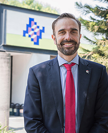 The photo shows Dr. Martin Lajous wearing a navy suit, blue shirt and red tie. 